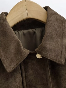 Detail view of dark chocolate suede bomber jacket collar with golden metallic buckle