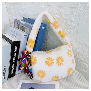Detail of soft white plush handbag with yellow daisy print and geometric silk scarf handle