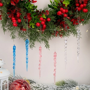 Macro view of spiral acrylic icicle ornaments hanging on a festive Christmas tree wreath