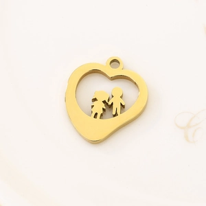 Detail of a gold stainless steel heart pendant with boy and girl cutouts for DIY jewelry