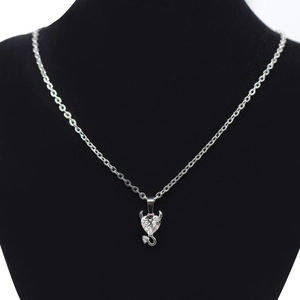 Devil heart pendant necklace with zircon stone on a black mannequin display neck