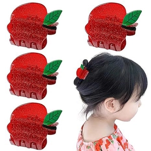 Glittery red apple hair claw clip with green leaf detail and child wearing style