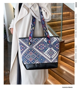 Close-up of ethnic woven canvas tote bag featuring blue and pink geometric patterns