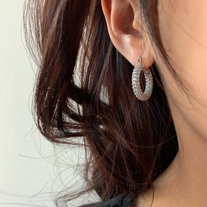 Sparkling zircon U-shaped silver hoop earrings worn by a model for a chic daily style