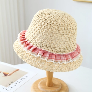 Straw sun hat with lace trim and pink floral ribbon detail on a wooden stand