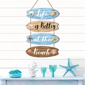 Coastal wooden surfboard wall decor with sea shells and 'Life is Better at the Beach' text