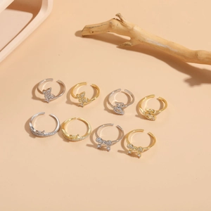Detailed view of 8-piece gold and silver adjustable rings with butterfly and zircon stones