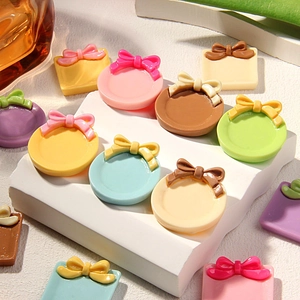 Colorful resin bow plates and hat miniatures for DIY crafts on a white display stand