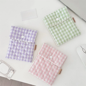 Detailed close-up of quilted plaid sanitary storage bags in purple, pink, and green colors