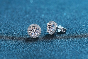 Macro shot of 925 silver stud earrings with round moissanite and halo pave setting