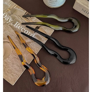 Three-piece U-shaped acetate hair pins in emerald, black, and tortoiseshell patterns