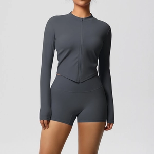 Detail view of dark charcoal gray yoga set with zip-up top and high waist biker shorts