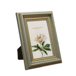 Vintage green and gold photo frame with rustic texture and desktop stand