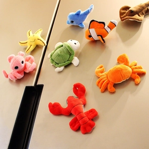 Set of 8 cute plush ocean animal magnets including dolphin, turtle and starfish on a fridge