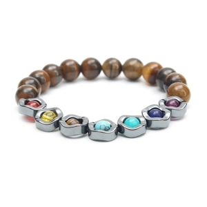 Close-up of tiger eye beads and grey metal links with colorful gemstones on a yoga bracelet