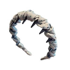 Polka dot light gray fabric headband with non-slip inner teeth on a white background