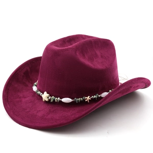 Detail of dark red suede cowboy hat with seashell and turquoise stone beaded band decoration