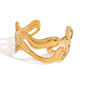 Polished 18k gold plated stainless steel bangle with wavy rib texture on white background