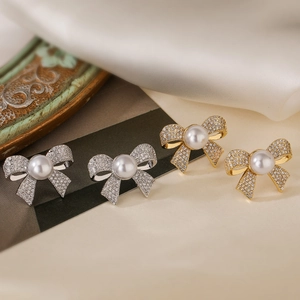 Exquisite 18K gold and silver bow stud earrings with sparkling zircons and white pearls