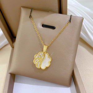 Close-up of a gold titanium steel floral necklace with crystals on a jewelry gift box