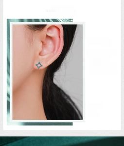 Close-up of 925 sterling silver four-point star studs with turquoise on model
