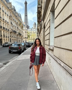 Detail view of burgundy faux woven leather bomber jacket with monogram texture in Paris