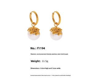 Detail of 18k gold plated flower stud earrings with large white shell pearls