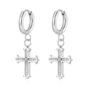 Detailed close-up of silver cross pendant earrings with sparkling clear zircon stones