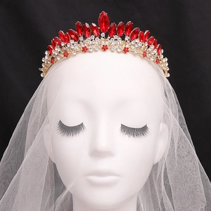 Luxurious bridal crown with red crystals and gold alloy base on a white veil