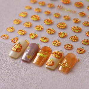 3D embossed Halloween pumpkin nail stickers with metallic gold and orange festive patterns
