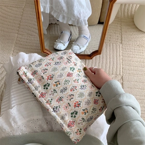 Floral cotton pouch with zipper closure being held in a cozy home lifestyle scene