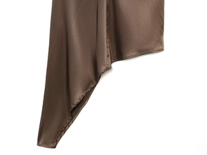 Close-up of chocolate brown satin fabric with a silky luster and asymmetrical hemline