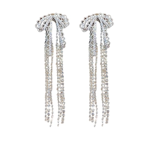 Elegant silver bow earrings with sparkling rhinestone tassels for a luxurious wedding look