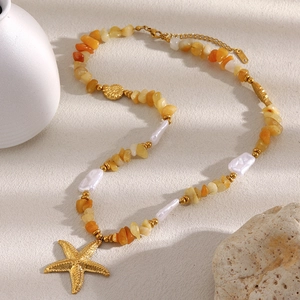 Detailed view of 18K gold plated necklace with orange natural stones and starfish charm