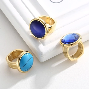 Detailed macro view of gold plated rings featuring turquoise and blue crystal stones