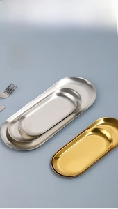 Macro view of tiered stainless steel oval trays with polished mirror finish surfaces