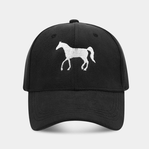 Detail of white horse embroidery on black suede-textured baseball cap with structured panels