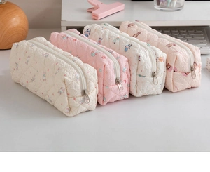 Detailed view of quilted cotton stationery pouches with cute animal prints and zippers