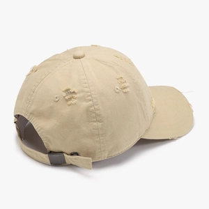 Distressed vintage beige cotton baseball cap with ripped details and adjustable metal buckle