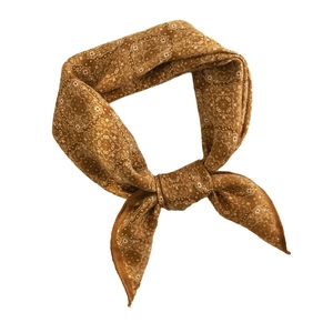 Elegant brown paisley print square silk scarf tied in a decorative knot on white background
