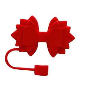 Detailed view of a red silicone bow straw topper for Stanley tumbler accessories