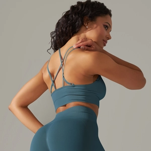 Detailed back view of a teal seamless ribbed sports bra with criss-cross strap design