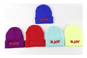 Detail of five colorful beanies featuring RAW embroidery and premium knit texture