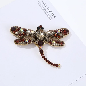 Macro shot of dragonfly brooch featuring vintage gold alloy and multicolor rhinestones