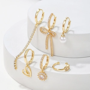 Golden 6-piece earring set featuring bow, heart, long tassel and pearls with zircon inlay