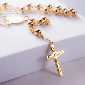 Polished gold plated titanium steel rosary necklace with crucifix cross pendant on white background