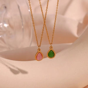 Detail of tear-drop cat eye stone pendants in pink and green with golden beaded edges