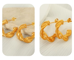 Detailed views of gold twisted C-shaped earrings with silicone backs on neutral stone