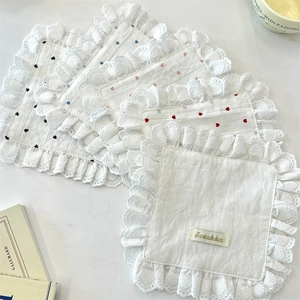 Detail of multi-purpose cloth coasters with heart patterns and delicate lace edges