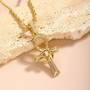 Gold Ankh cross necklace with Eye of Horus and pavé cubic zirconia on stone base